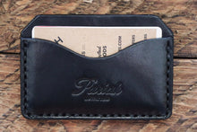 Black handmade and hand stitched horizontal card case wallet on wood