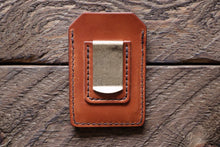 Brown handmade and hand stitched money clip wallet on wood