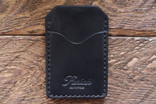 Black handmade and hand stitched money clip wallet on wood