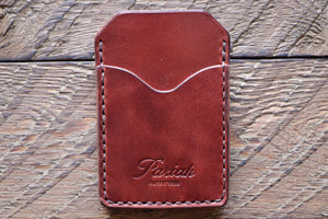 Brown handmade and hand stitched money clip wallet on wood